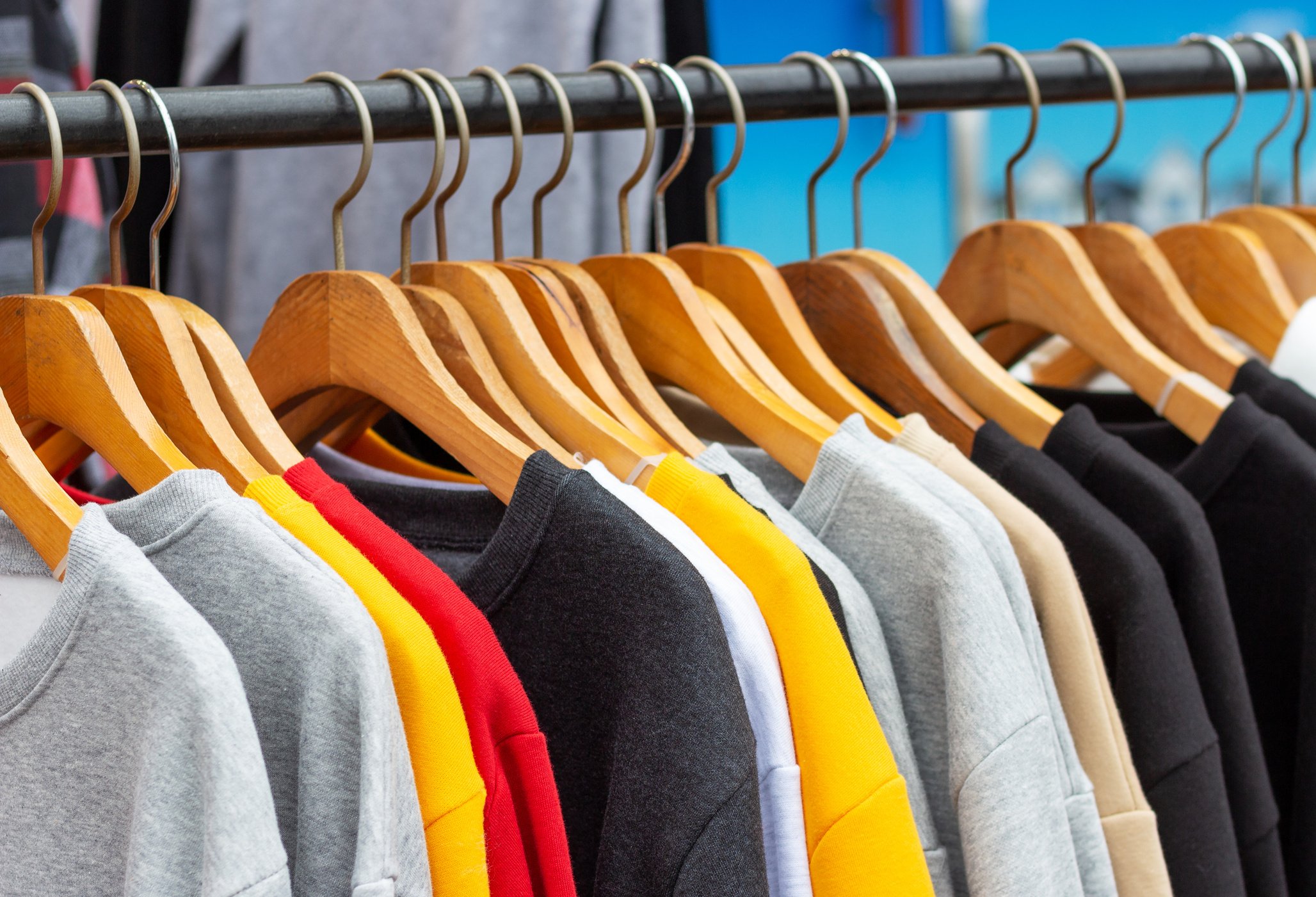 Sweatshirts on Hangers in Sports Store Close-up